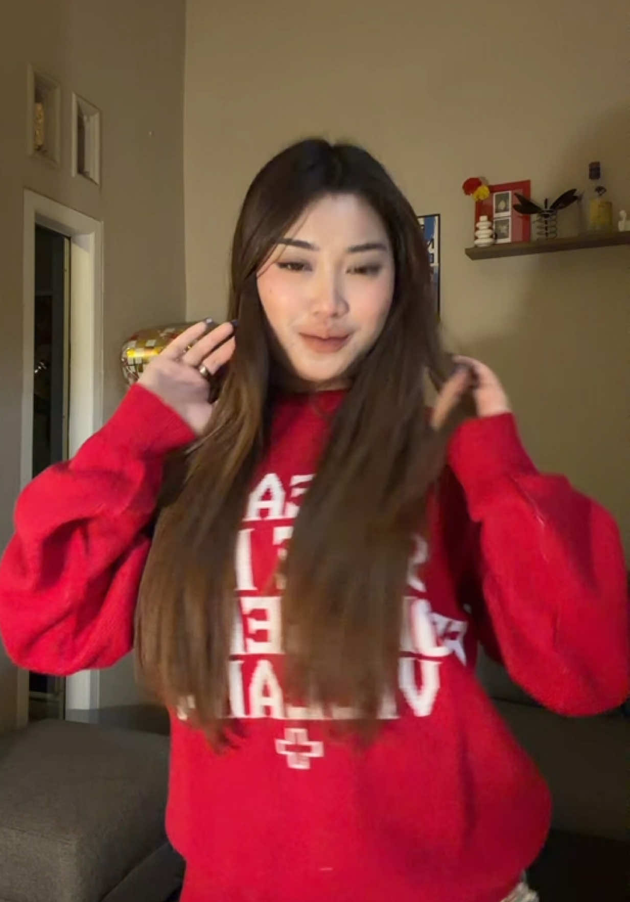 Dynamic pop music plays, the woman sways her body and tidies her hair to the rhythm,… TikTok video